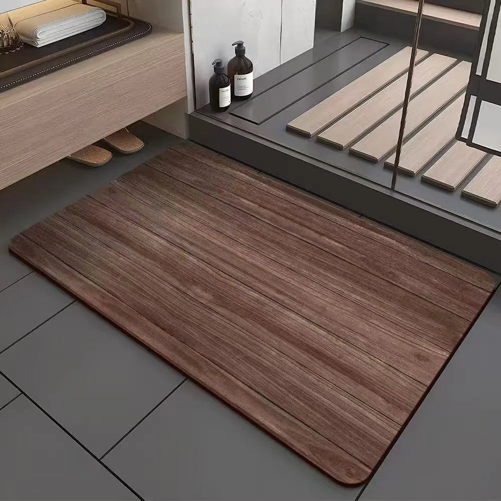Square diatomite bathroom floor mat with geometric print in a wood grain colour on a tiled floor.
