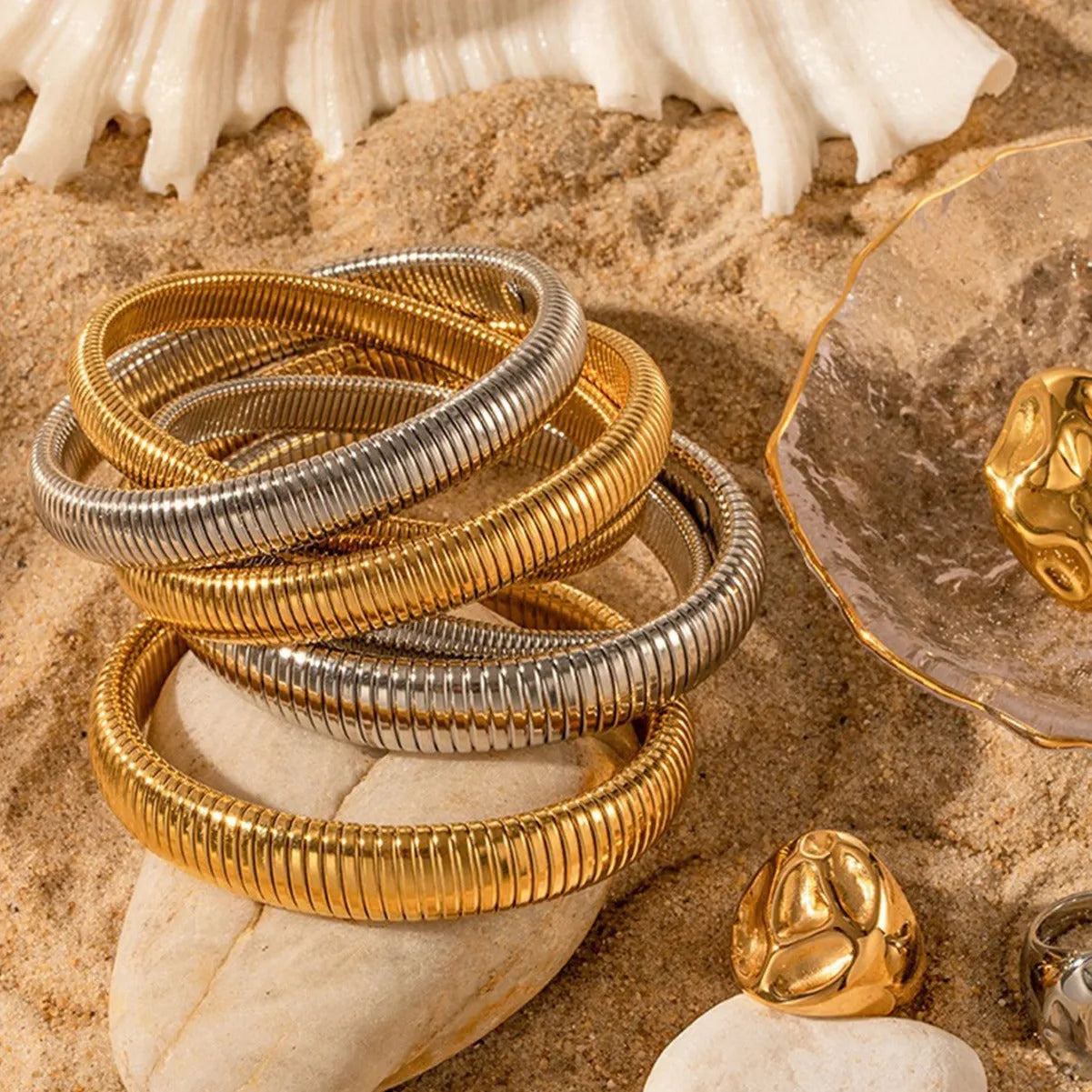 Gold titanium steel women's bracelet with elastic band and vertical stripe ring pattern, shown at 2cm width.