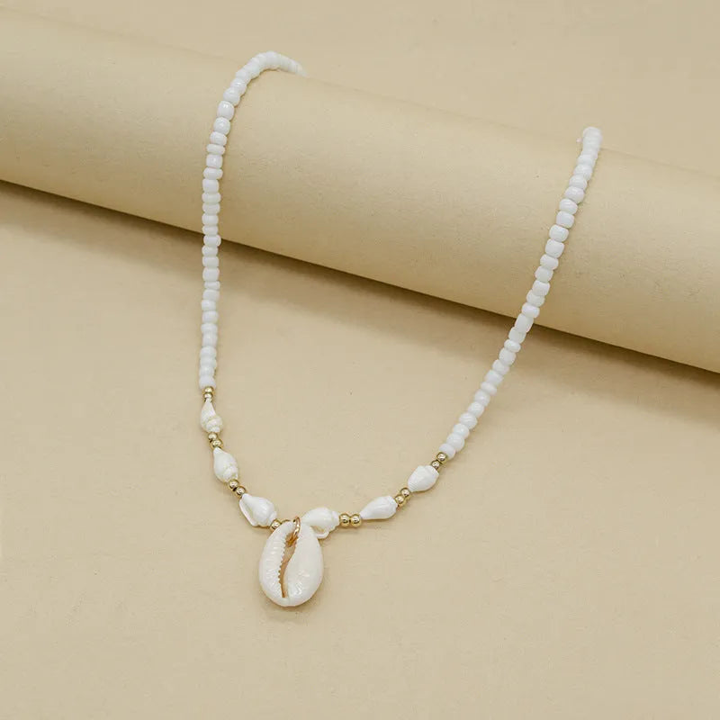 White conch shell bead necklace with a real mother-of-pearl pendant on a regular chain.