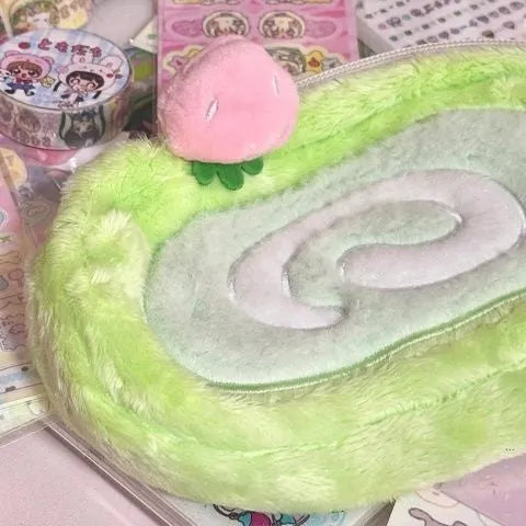 Honeydew Swiss roll cake design velvet pencil case on a flat surface