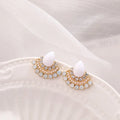Silver fan-shaped drop earrings with rhinestone and opal geometric design on white background