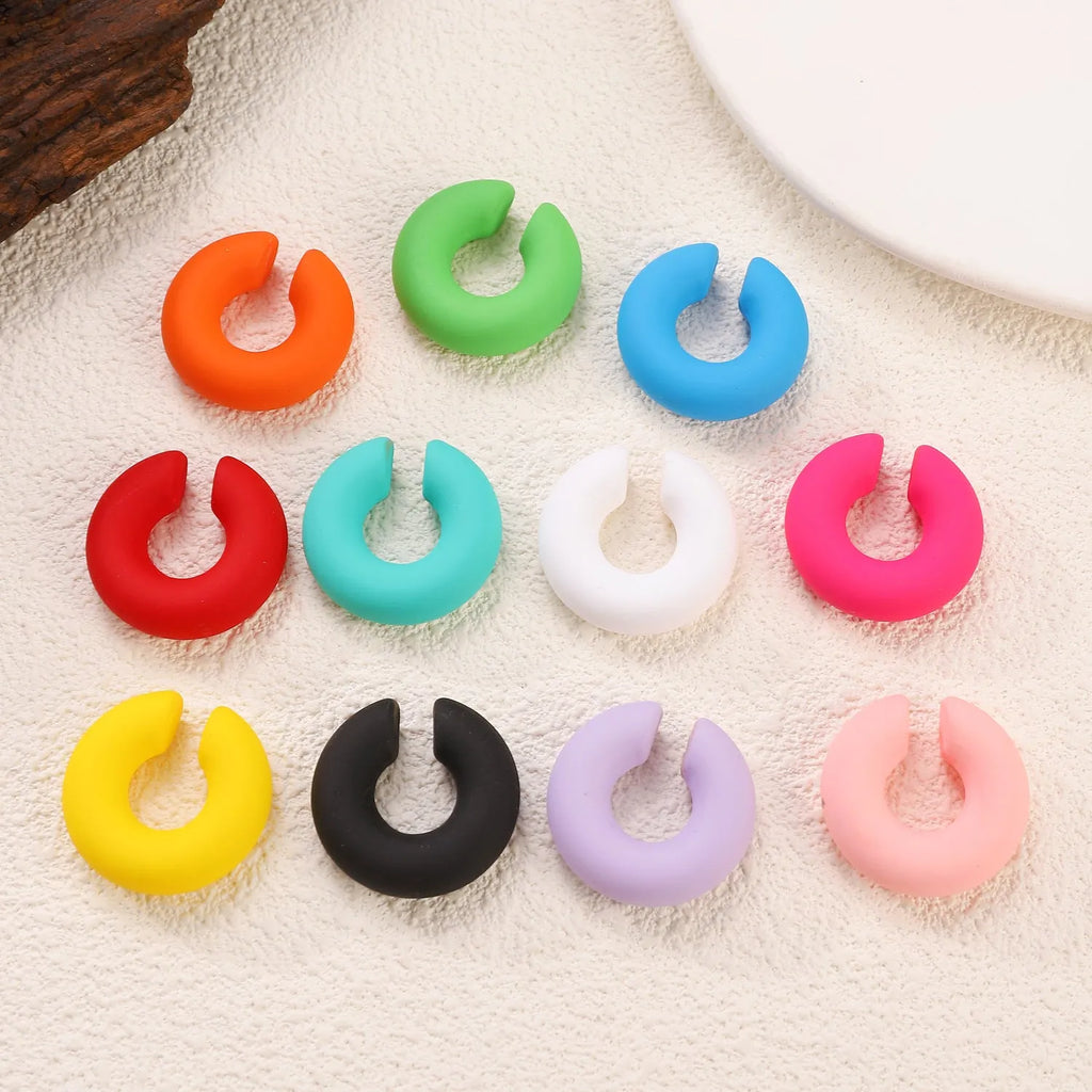Matte finish geometric C-shaped clip-on earrings in candy colours for women without pierced ears