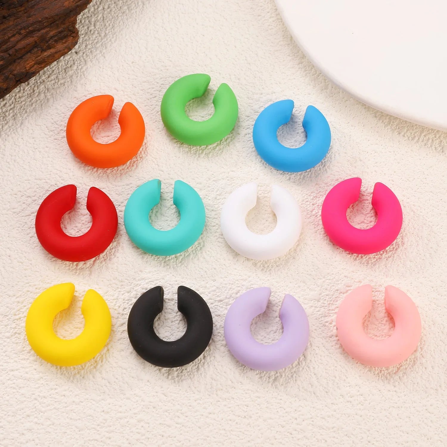 Matte finish geometric C-shaped clip-on earrings in candy colours for women without pierced ears
