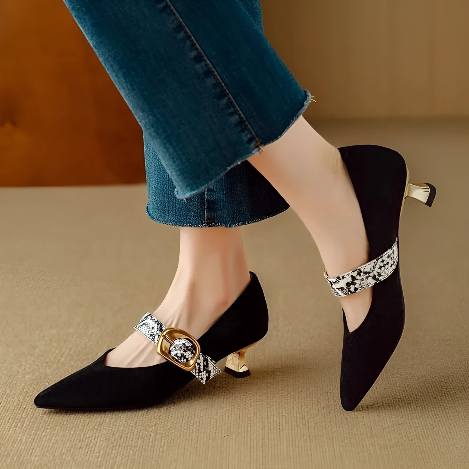 Black and brown women's pointed toe stiletto heels with a buckle fastener and mid-height heel.
