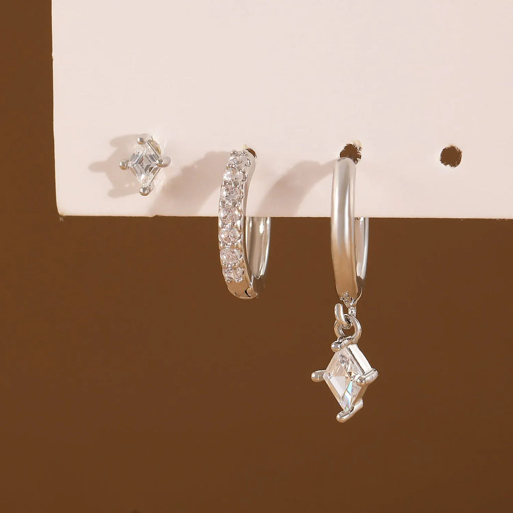 Ladies three-piece earring set with geometric designs and zircon accents in gold or white finish