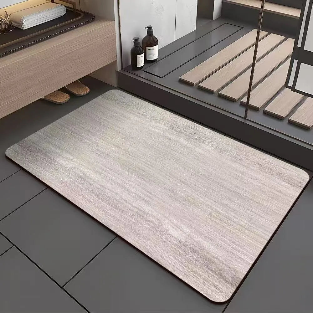 Square diatomite bathroom floor mat with geometric print in a wood grain colour on a tiled floor.