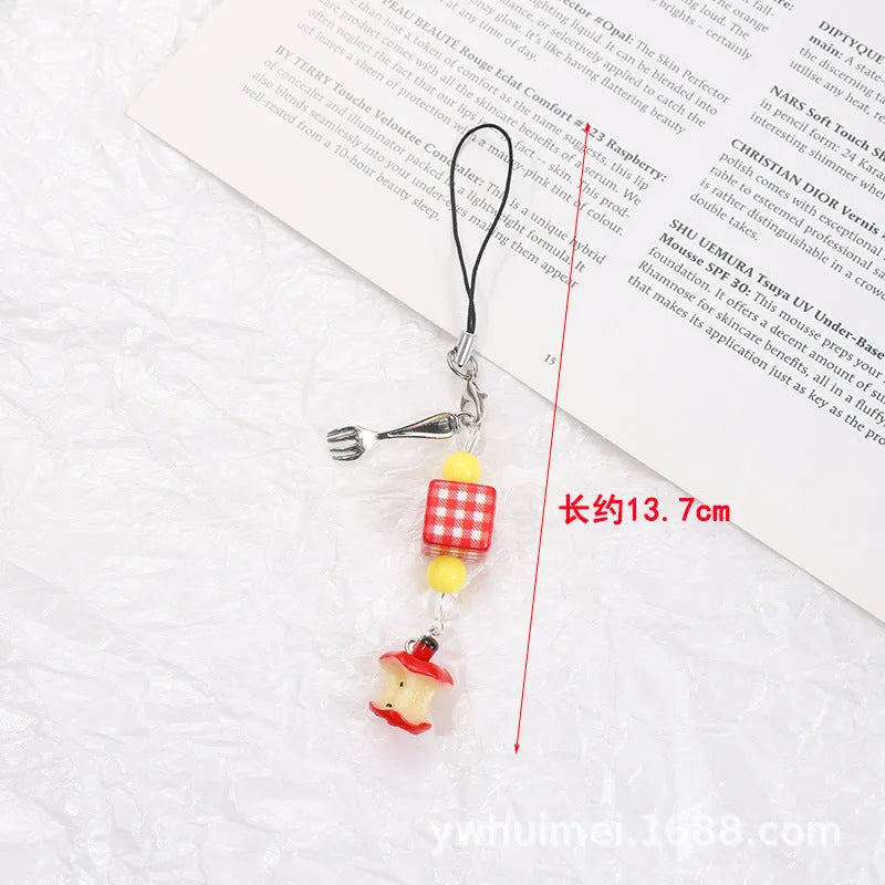 Plastic resin fruit charm keychain with removable rope in strawberry, green apple, and red apple designs.