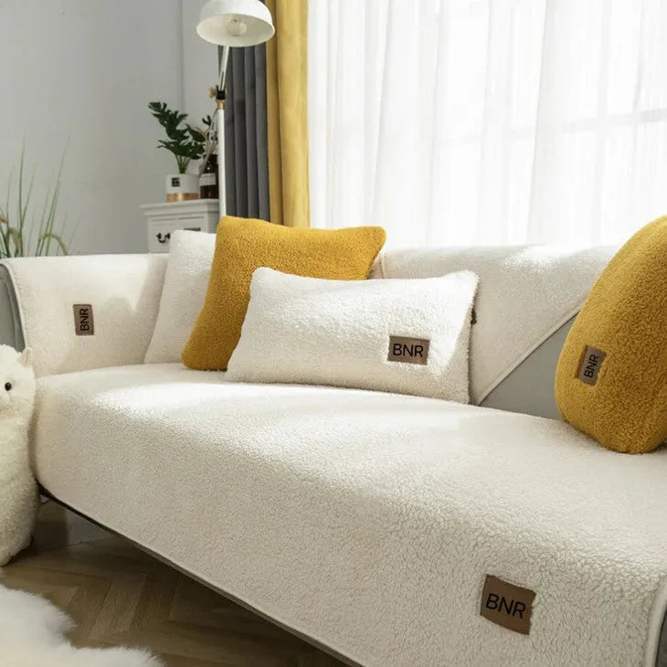 Lambswool sofa cover in solid blue colour on a three-seater sofa