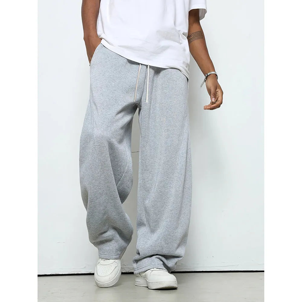 Men's solid colour straight-leg casual trousers with a drawstring waist on a hanger.