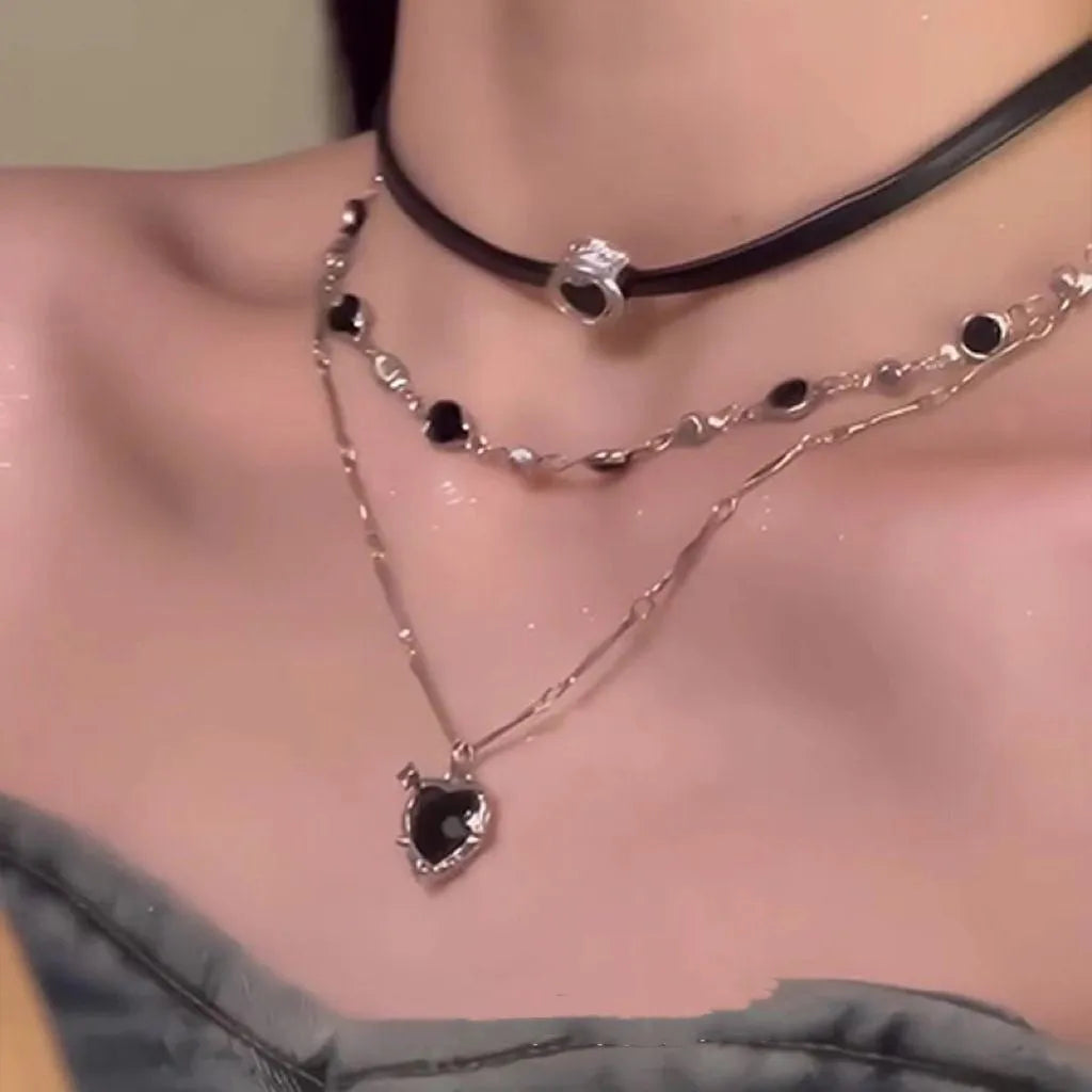 Women's twin necklace set showing double-layer leather heart and single-layer love designs with alloy and crystal elements