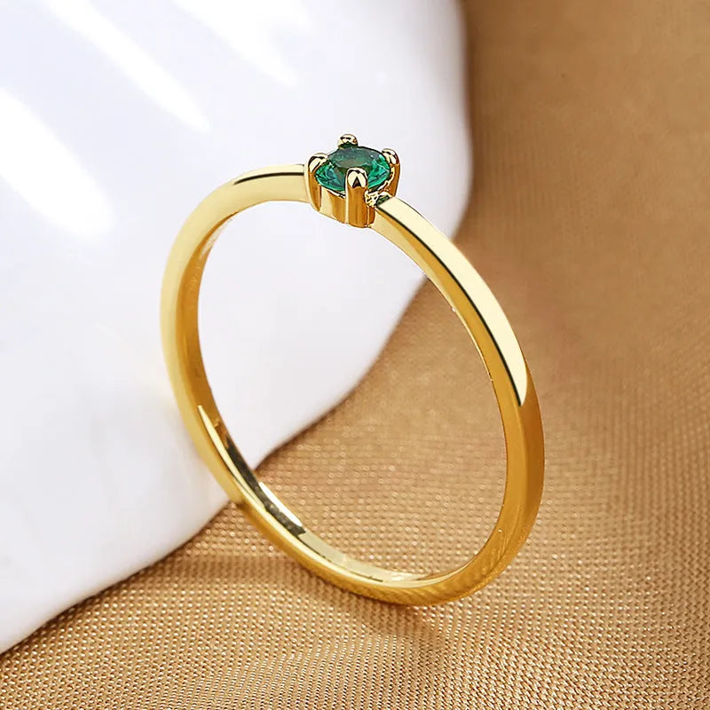 Women's copper fine circle ring with a single diamond in a geometric setting, shown on a hand.