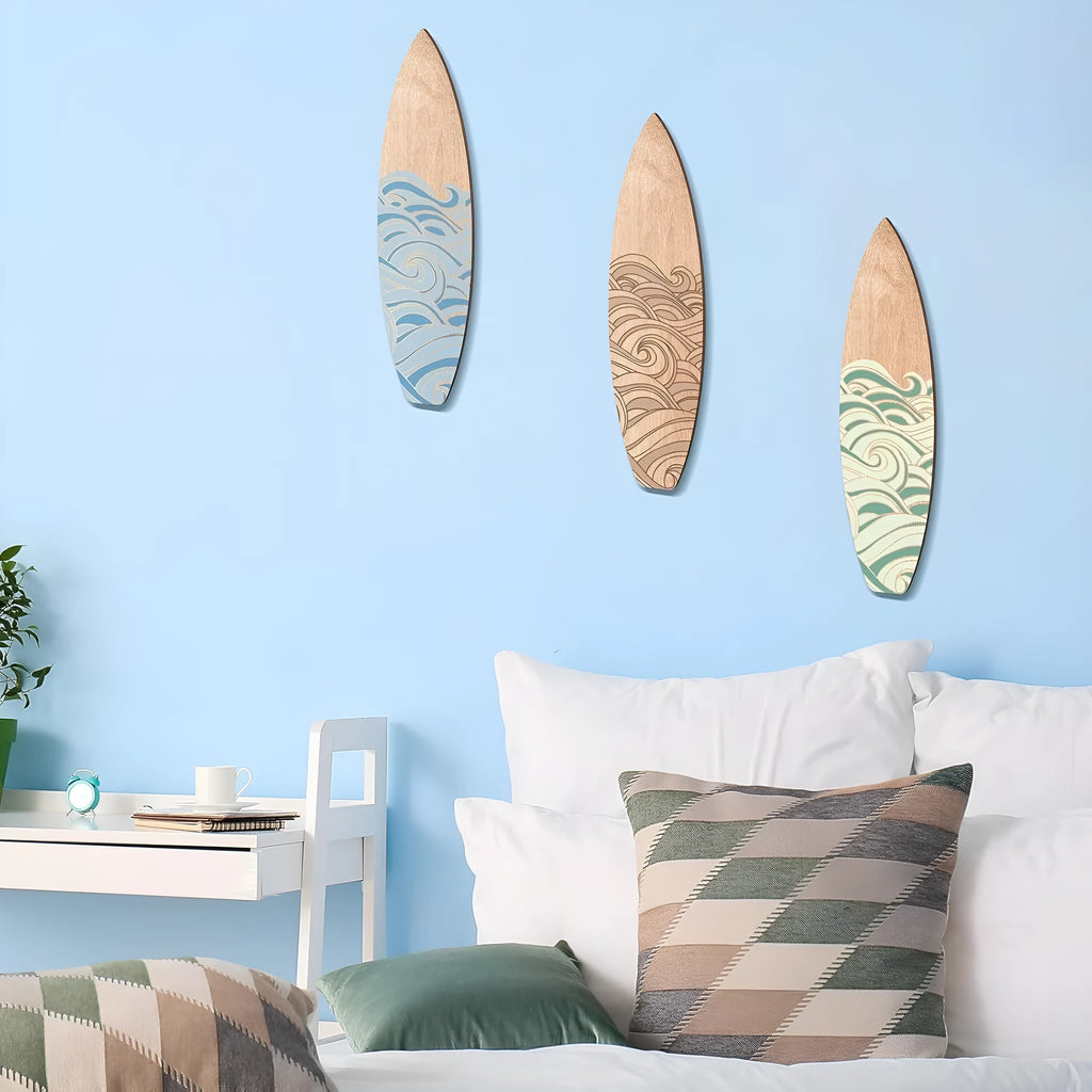 Set of three natural wood surfboard wall decorations on a white background