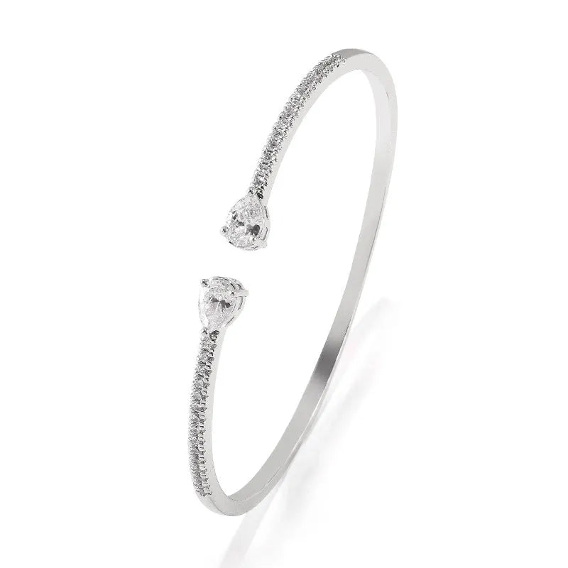 Copper bracelet with inlaid white zircon crystals on a simple band.