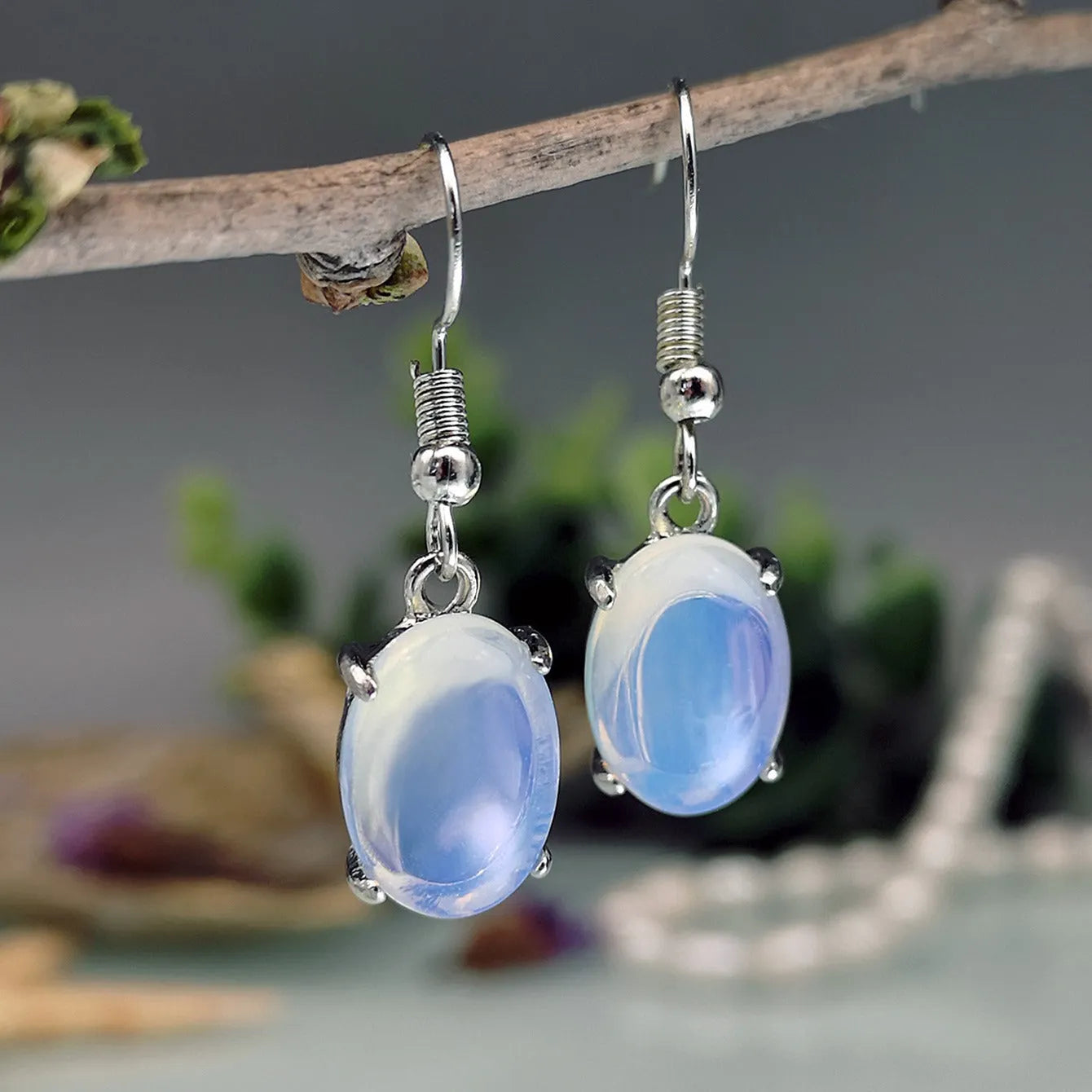 Opal earrings with retro moonstone cross design and ellipse elements in drop shape