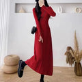 Women's beige high waist A-line knitted midi dress with regular sleeves on a mannequin.