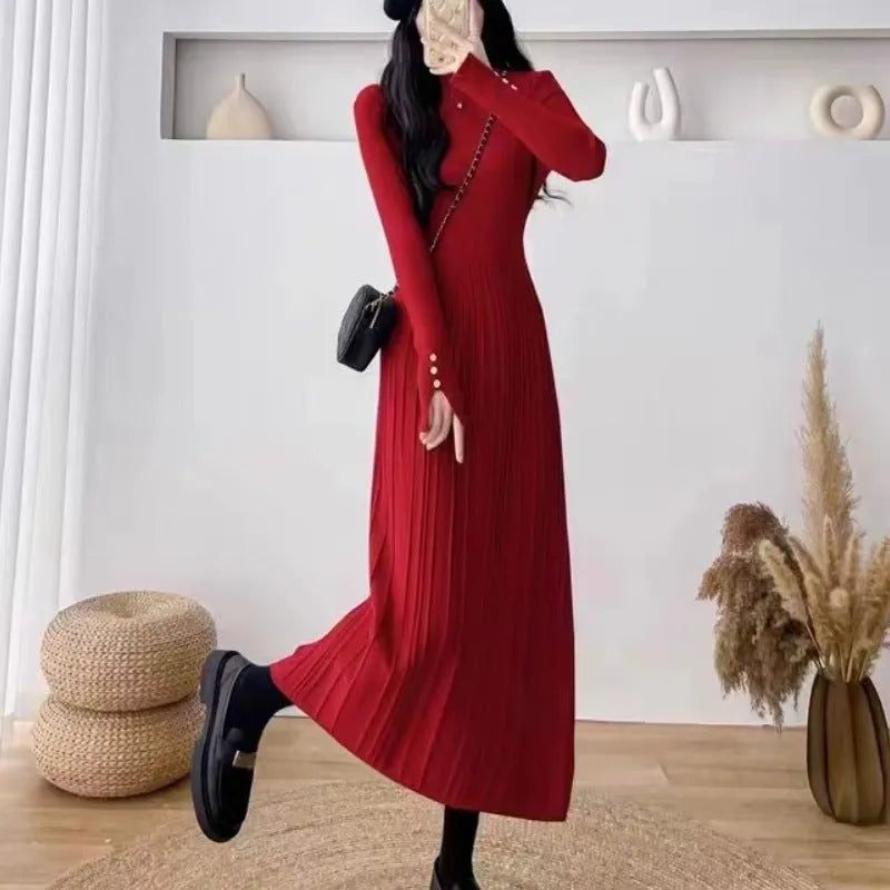 Women's beige high waist A-line knitted midi dress with regular sleeves on a mannequin.