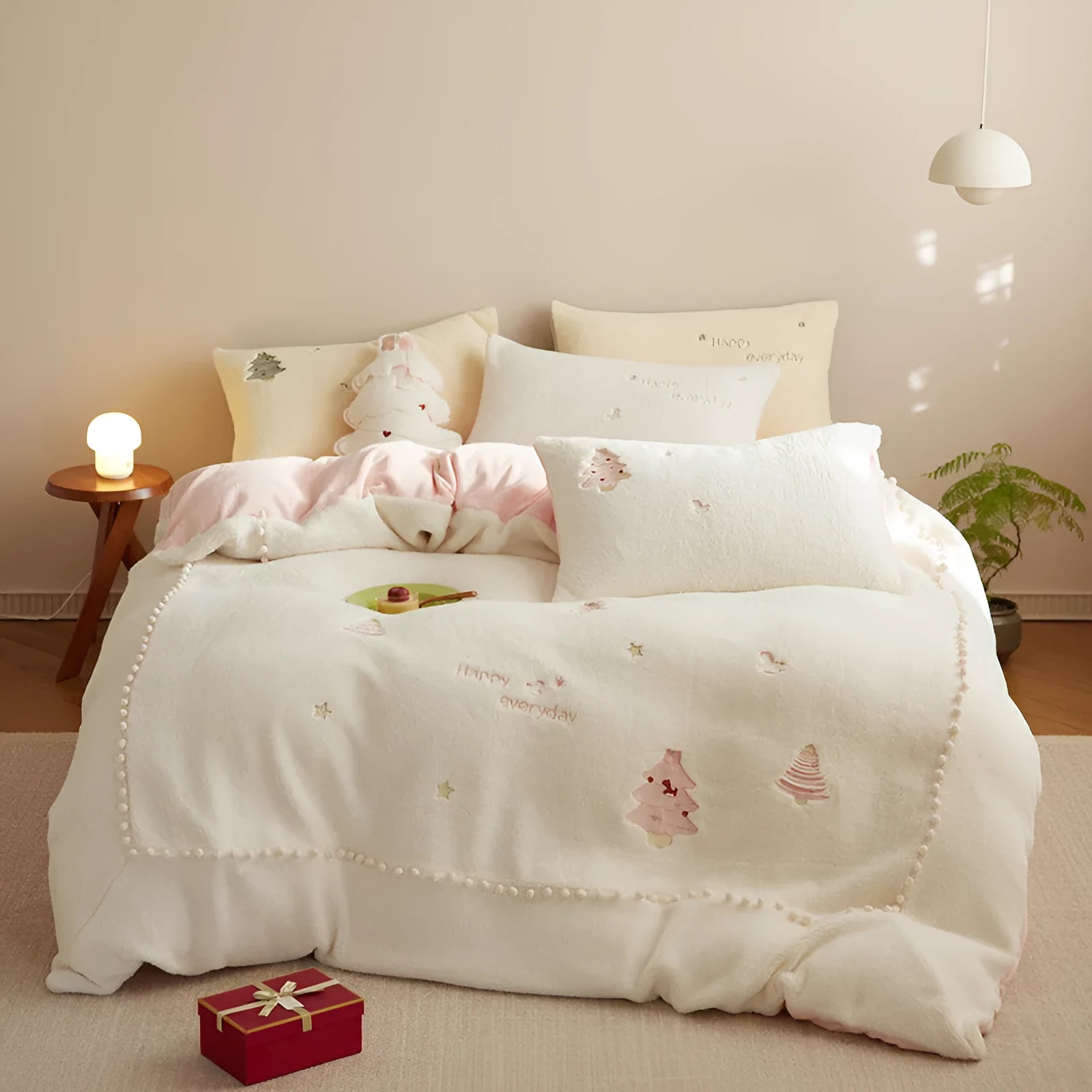 Milk fibre Christmas bedding set with reactive printed tree pattern shown on bed