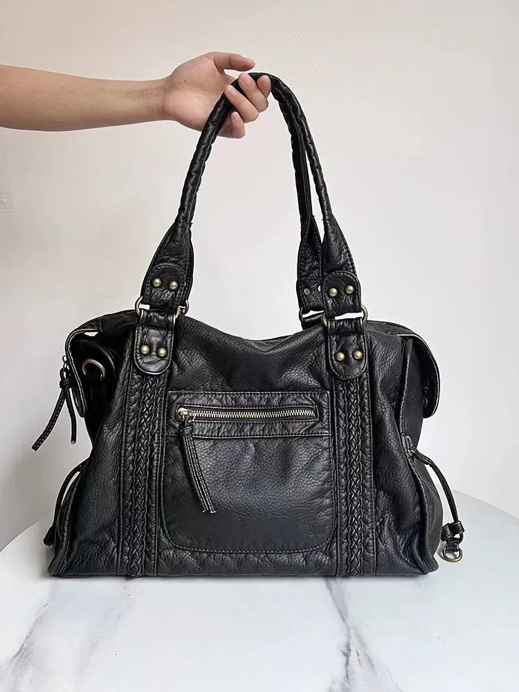 Women's retro motorcycle messenger shoulder bag with woven detail showing organised interior compartments