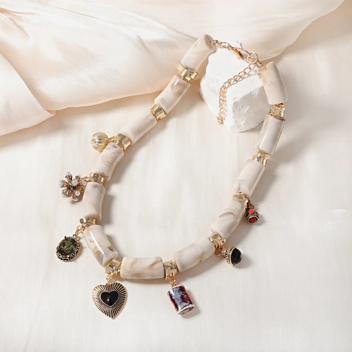 Electroplated heart-shaped resin necklace with bamboo design elements