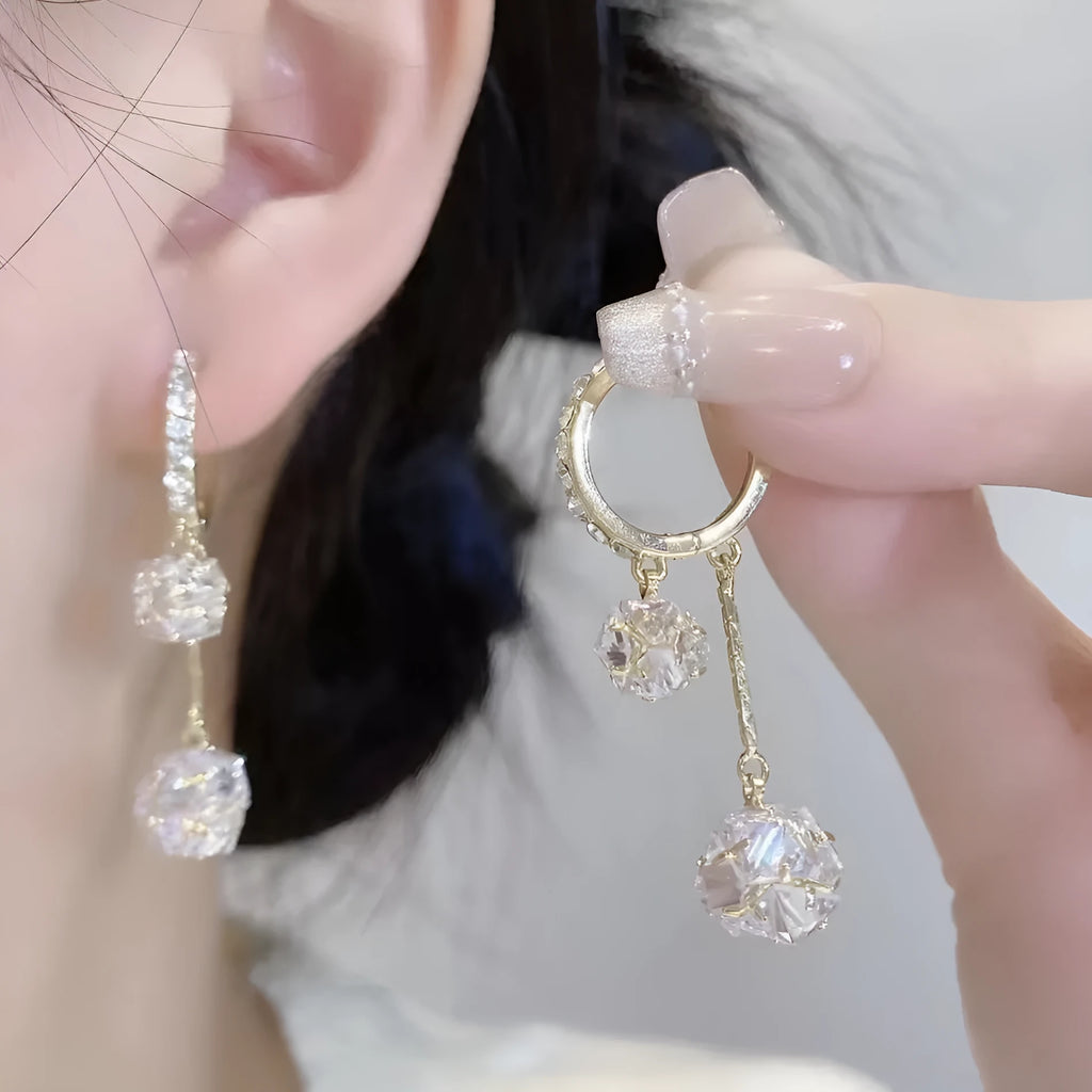 Women's silver drop earrings with confession balloon and rhinestone ball pendants connected by tassel detailing