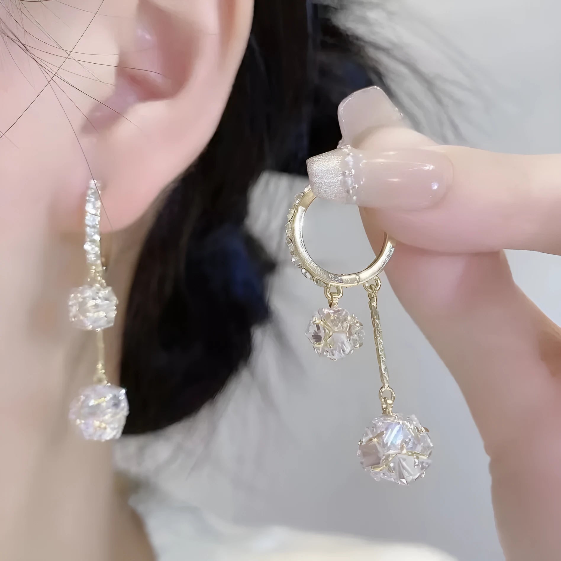 Women's silver drop earrings with confession balloon and rhinestone ball pendants connected by tassel detailing