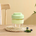Green plastic salad cup with clear lid and spoon, sealed leak-proof design.