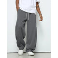 Men's solid colour straight-leg casual trousers with a drawstring waist on a hanger.