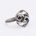Close-up of a retro-style double snake ring made from titanium steel in a steel colour finish.