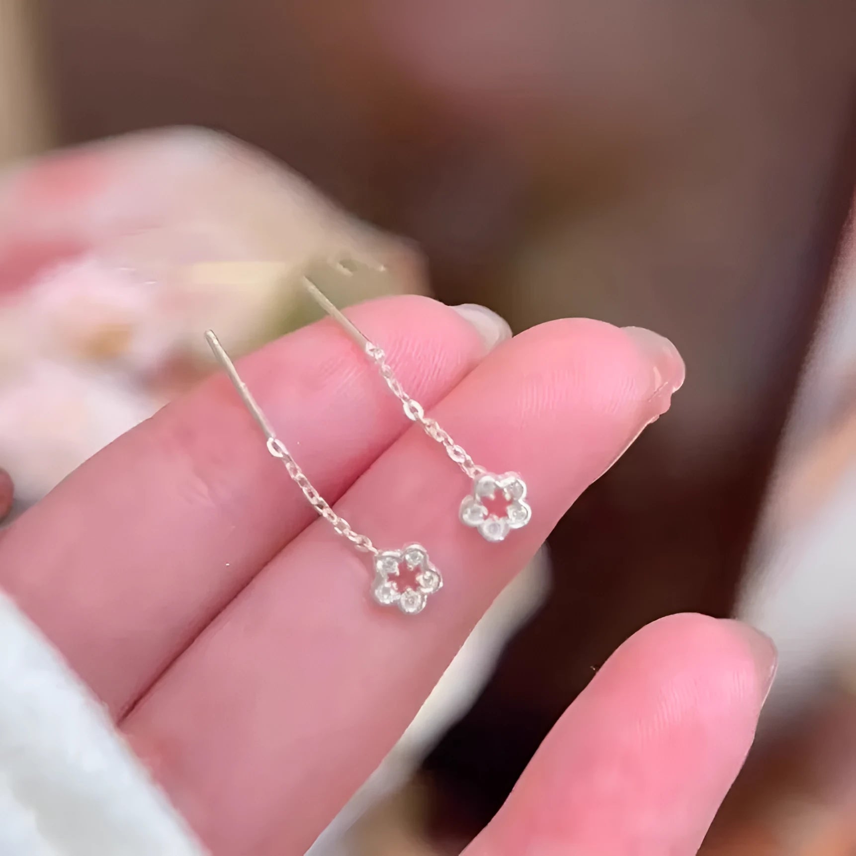 Silver colour flower hanging earrings with natural petal design and needle posts