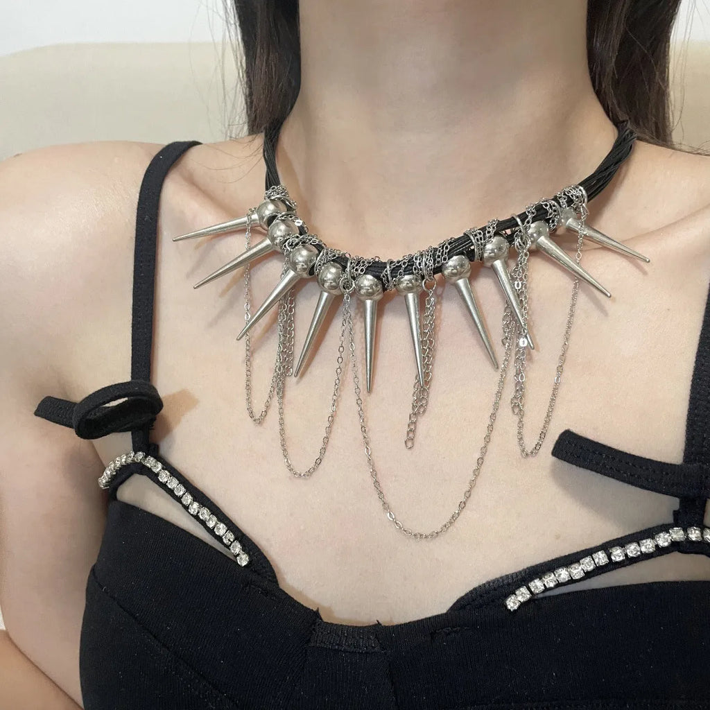 Women's leather necklace with electroplated finish showing rivet decoration and winding tassel design with round beads