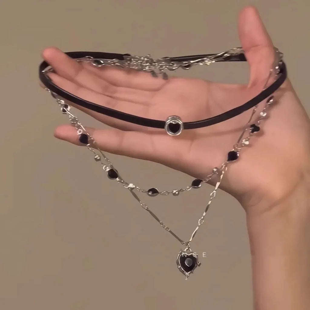 Women's twin necklace set showing double-layer leather heart and single-layer love designs with alloy and crystal elements