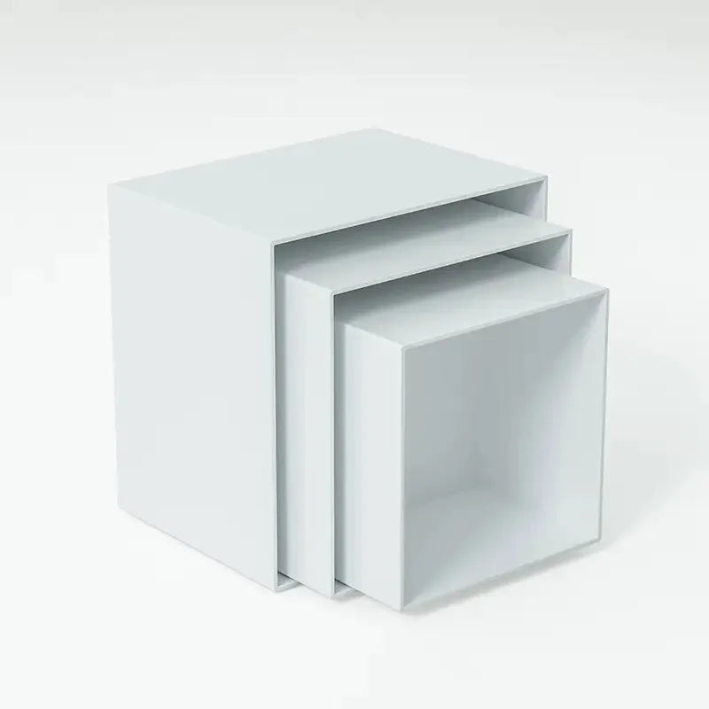 White plastic cube dessert display stand with six modular pieces arranged on tabletop