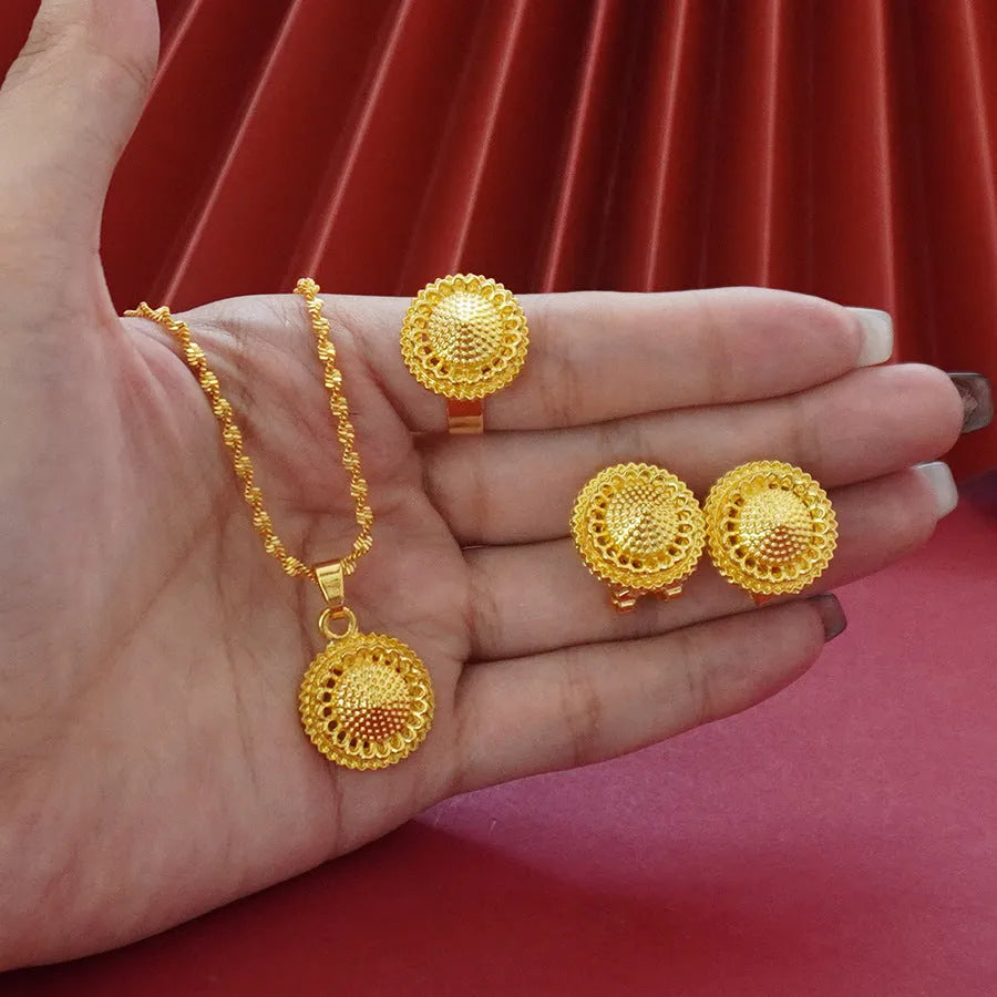 Gold-plated three-piece jewelry set showing necklace, earrings, and ring with a detailed flower design pendant.