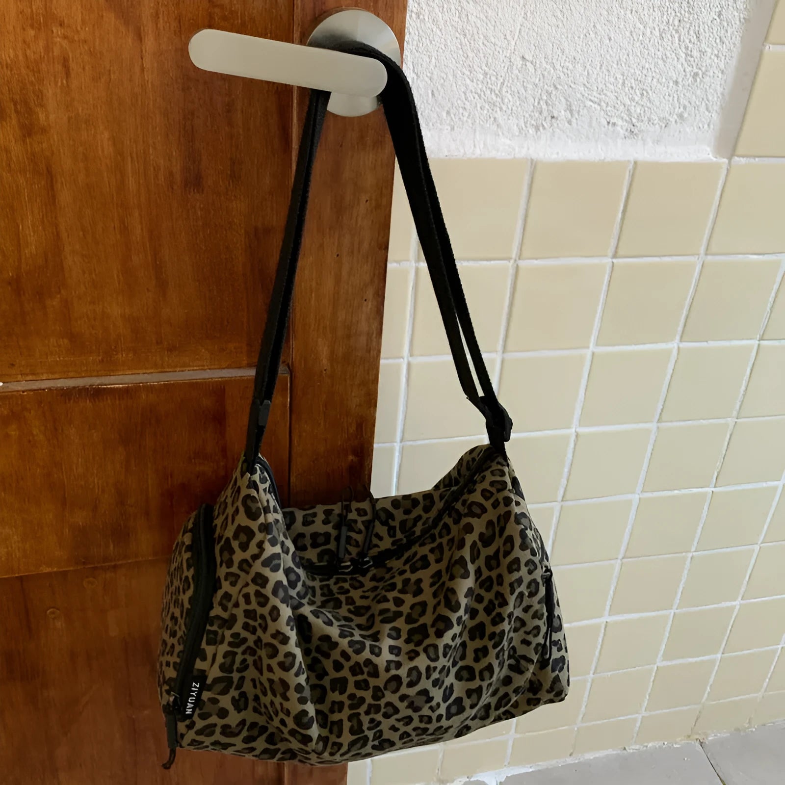 Large capacity leopard print sports messenger bag with cross-body strap and stitching details