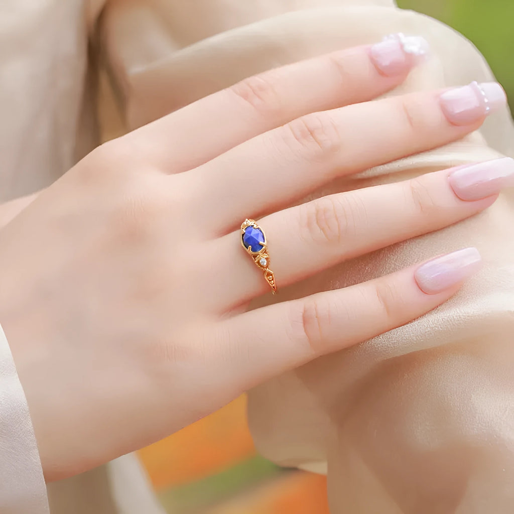 Geometric ellipse lapis lazuli silver ring with Japanese style design on a model's hand.