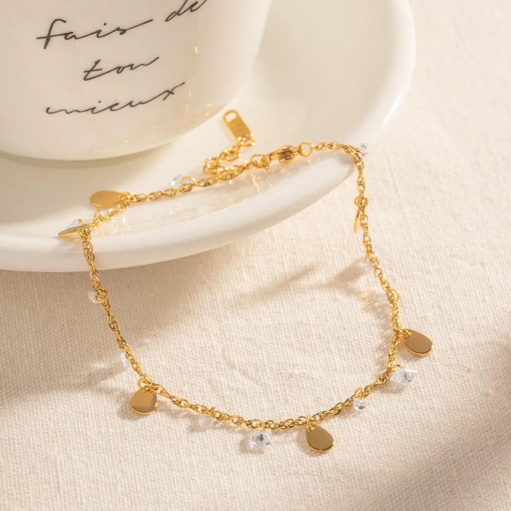 Women's stainless steel geometric anklet with water drop pendant and tassel detailing