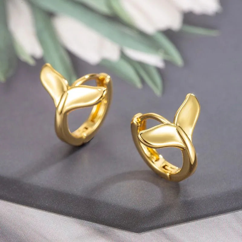 A pair of women's simple fishtail design earrings in an electroplated gold colour.