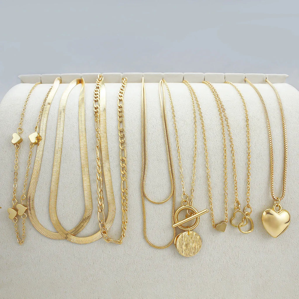 Gold electroplated women's necklace set with 10 pieces featuring snake bone chains and alloy pendants