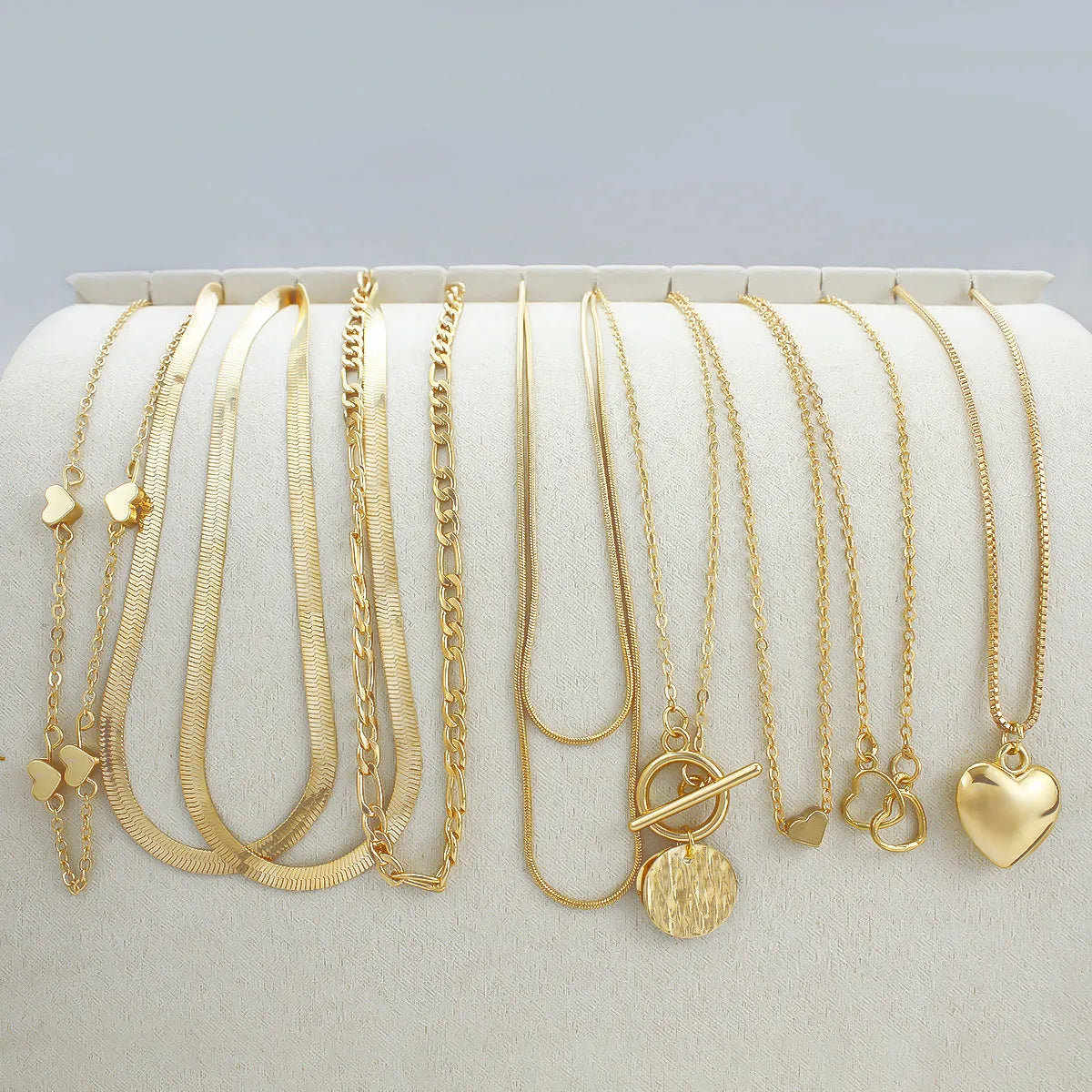 Gold electroplated women's necklace set with 10 pieces featuring snake bone chains and alloy pendants