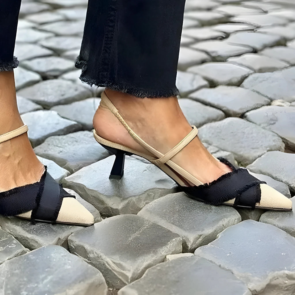 Apricot and black colour-block women's stiletto sandals with a pointed toe and ankle buckle.