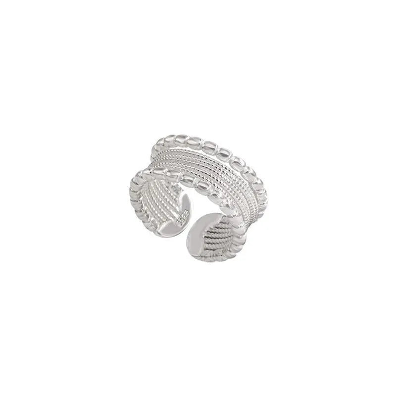 Geometric brass ring with adjustable opening and woven twisted layers