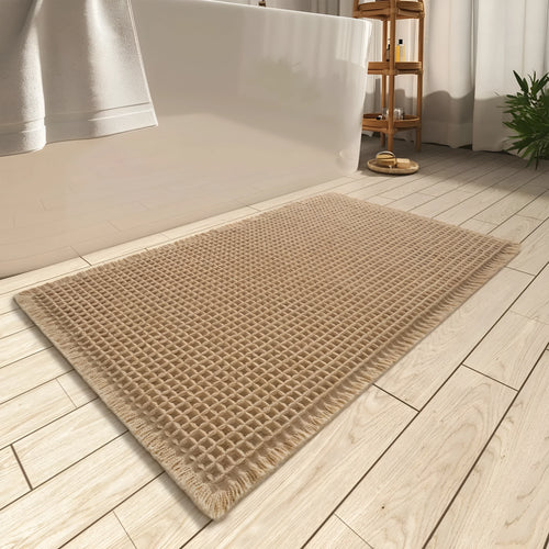 Modern checkered pattern absorbent non-slip bathroom floor mat in a neutral colour on tiled floor.