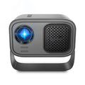 Black HD portable projector with Android system, remote control, and cables on desk