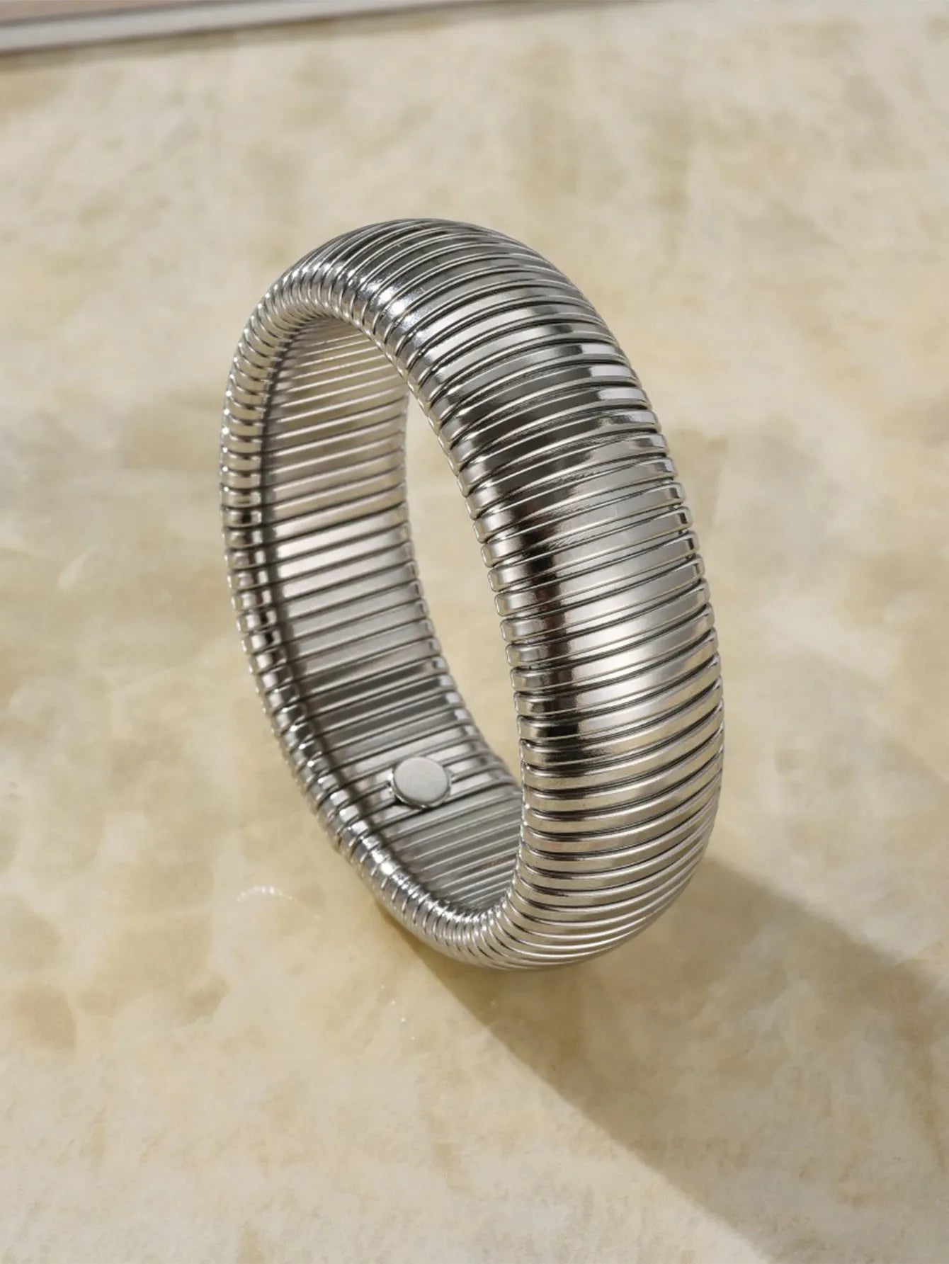 Gold titanium steel women's bracelet with elastic band and vertical stripe ring pattern, shown at 2cm width.
