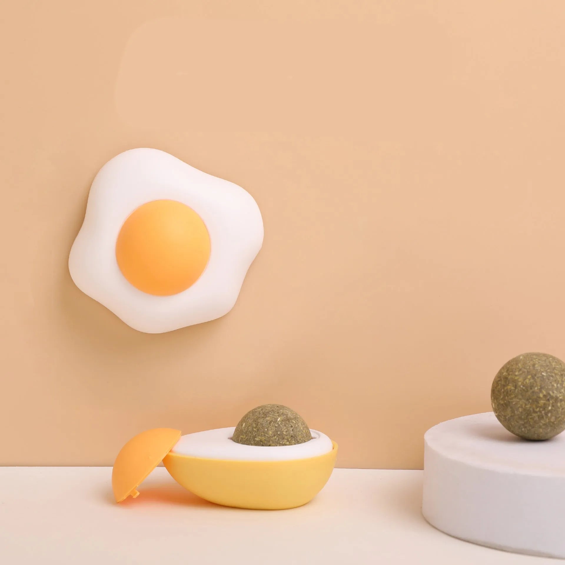 Soft plush catnip ball toy attached to wall for interactive feline play