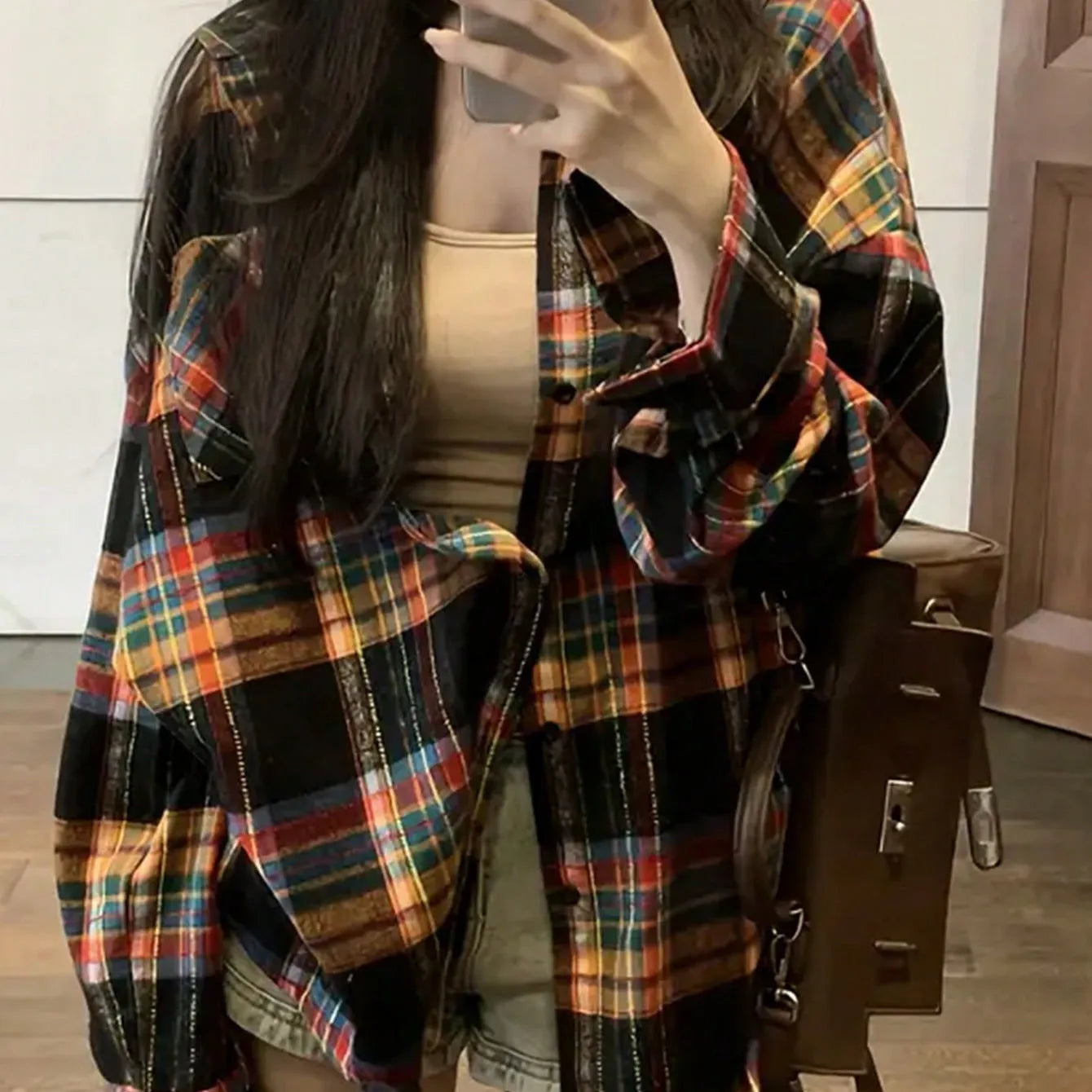 Women's loose fit black plaid long sleeve cotton shirt on a hanger.