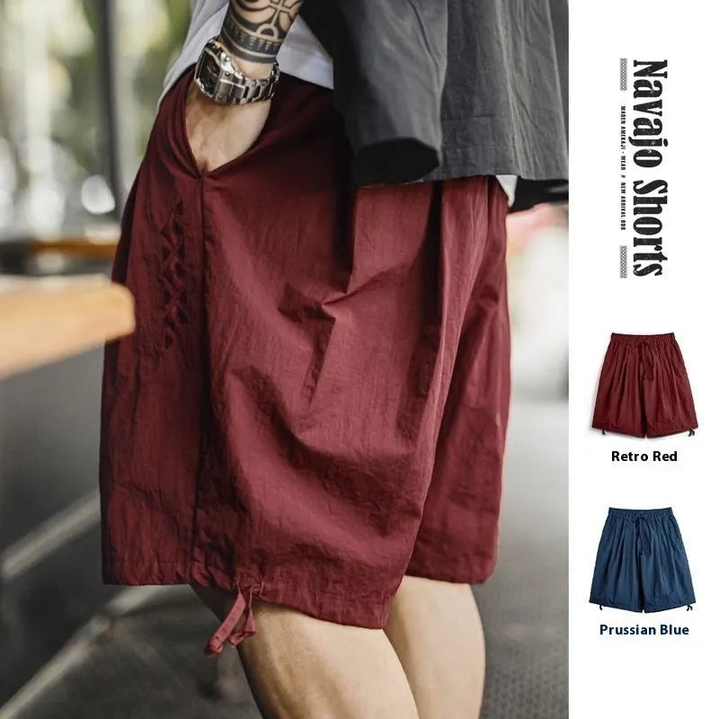 Men's loose fit embroidered beach shorts in Prussian Blue with thin nylon fabric