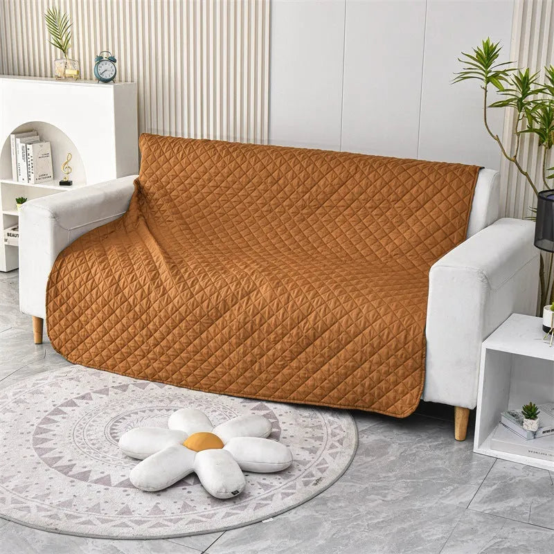 Reversible waterproof dog blanket laid flat on a sofa, showing two colour options.