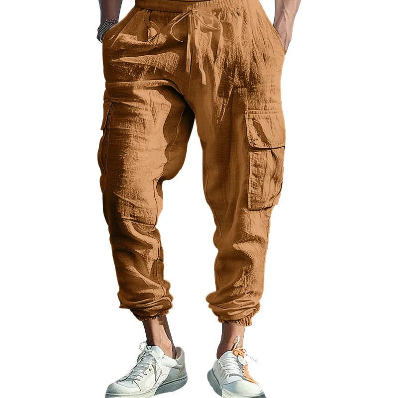 Men's loose-fit linen trousers with ankle-tied cuffs and multiple pockets.