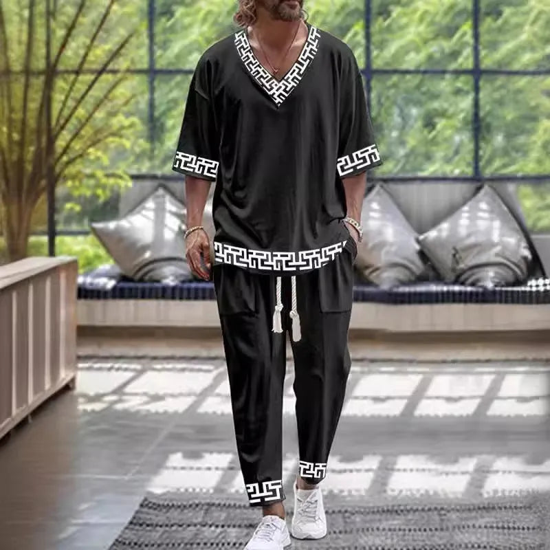 Cropped sleeve V-neck trousers suit set in thin polyester fabric on a hanger.